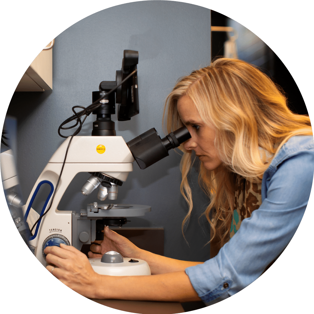 Dr. Kate McGowan looking into a microscope