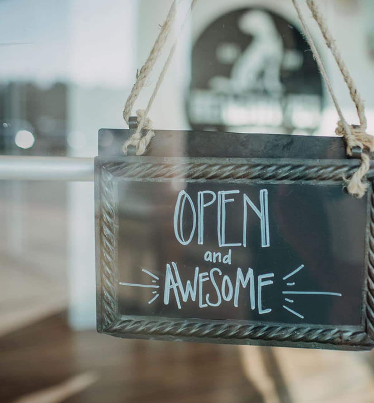 A sign on a door reading, "Open and Awesome"